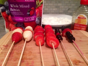Image of mixed fruit on wooden skewers, with yogurt
