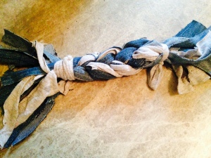 Image of denim and t-shirt strips braided together and tied at ends